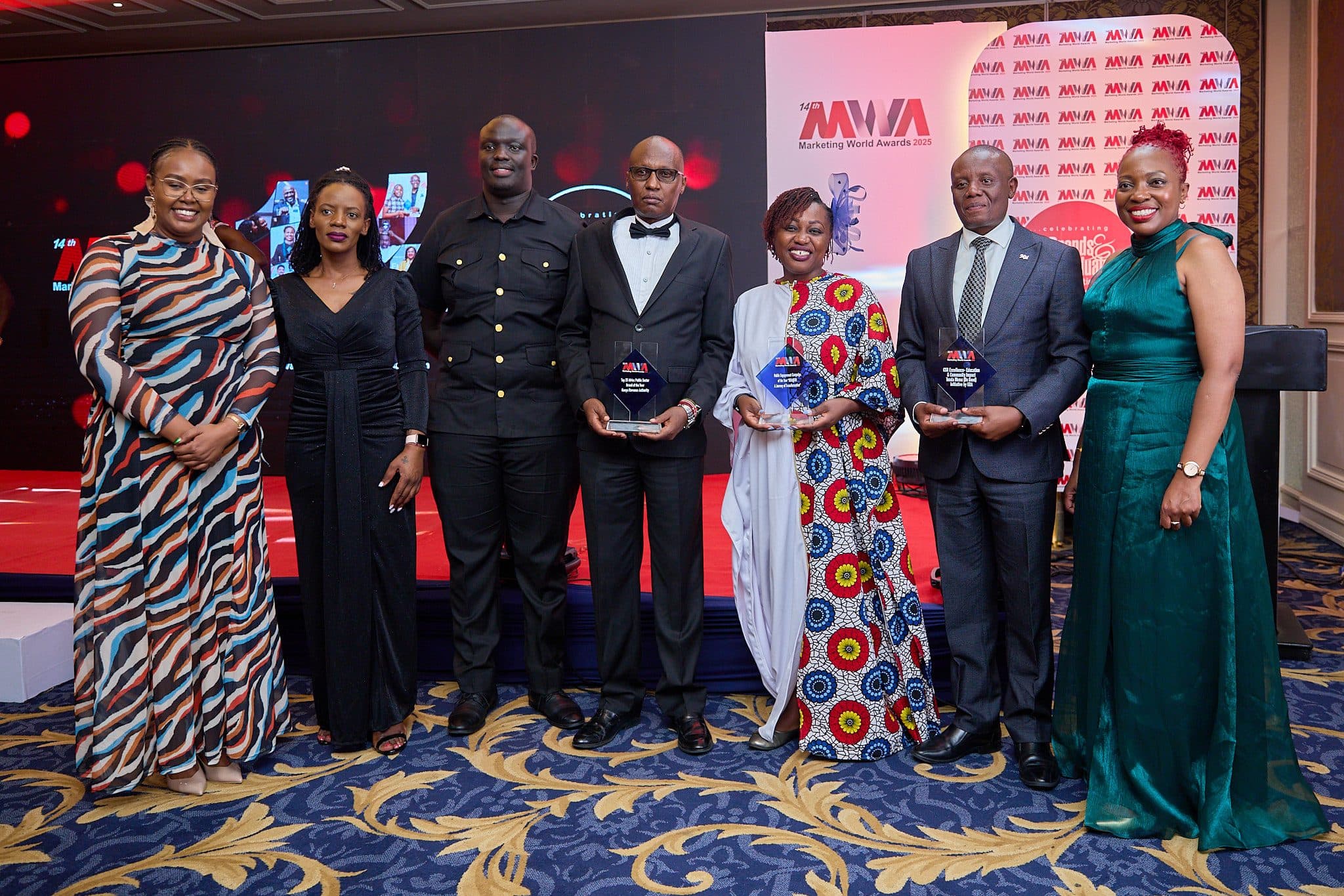 A team of winners celebrating on stage at the Marketing World Awards